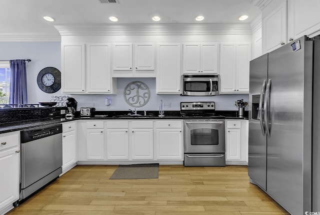 113-A Vista Dr, Garden City Beach, SC 29576 - kitchen with appliances with stainless steel finishes, ornamental molding, white cabinetry, recessed lighting, and a sink