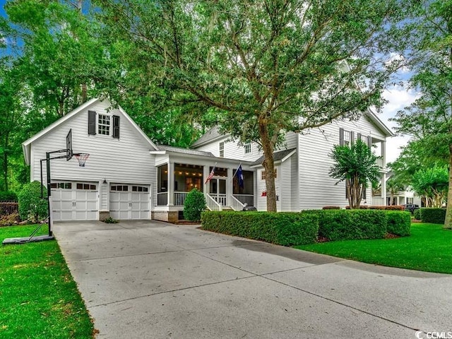 9 Winnowing Way, Pawleys Island, SC 29585 - view of front of house featuring covered porch, a garage, concrete driveway, and a front yard