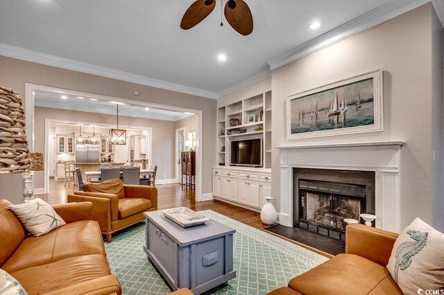 9 Winnowing Way, Pawleys Island, SC 29585 - living room with ceiling fan, dark wood-style floors, crown molding, baseboards, and built in shelves