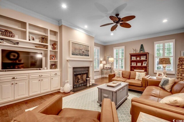 9 Winnowing Way, Pawleys Island, SC 29585 - living area featuring a ceiling fan, crown molding, wood finished floors, a fireplace, and recessed lighting