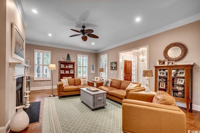 9 Winnowing Way, Pawleys Island, SC 29585 - living room with a ceiling fan, light wood-style floors, baseboards, ornamental molding, and a fireplace with flush hearth