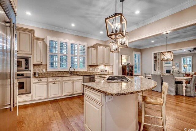 9 Winnowing Way, Pawleys Island, SC 29585 - kitchen with built in appliances, a sink, open floor plan, a chandelier, and light wood-style floors