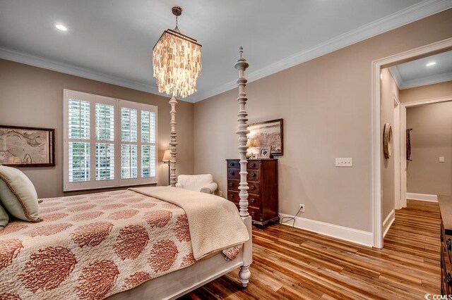 9 Winnowing Way, Pawleys Island, SC 29585 - bedroom featuring wood finished floors, crown molding, baseboards, a chandelier, and recessed lighting