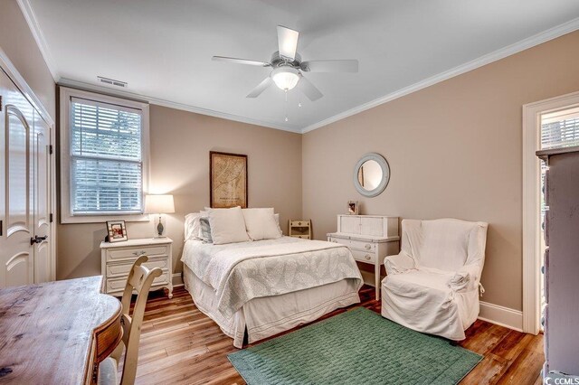 9 Winnowing Way, Pawleys Island, SC 29585 - bedroom with ornamental molding, light wood finished floors, multiple windows, baseboards, and ceiling fan