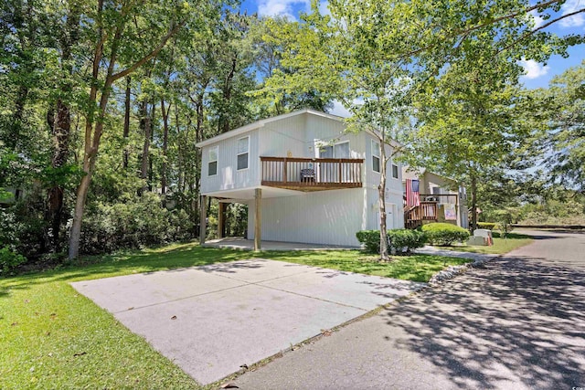 739 Tall Oaks Dr, Myrtle Beach, SC 29588 - view of front facade with a front yard and a carport