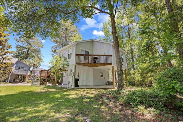 739 Tall Oaks Dr, Myrtle Beach, SC 29588 - rear view of house featuring a yard, central air condition unit, a wooden deck, a patio, and stairway