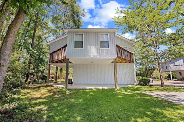 739 Tall Oaks Dr, Myrtle Beach, SC 29588 - back of property featuring a yard, a patio area, a wooden deck, and central AC