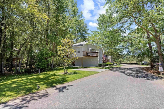 739 Tall Oaks Dr, Myrtle Beach, SC 29588 - view of front facade with a front yard, driveway, and a balcony