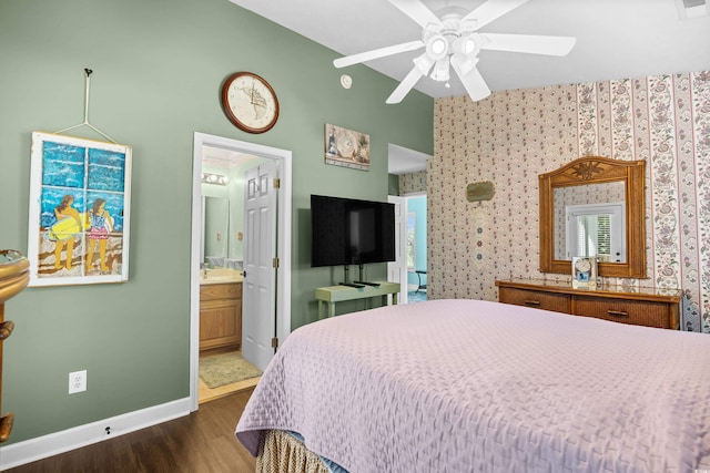 739 Tall Oaks Dr, Myrtle Beach, SC 29588 - bedroom with dark wood finished floors, baseboards, wallpapered walls, lofted ceiling, and ensuite bathroom