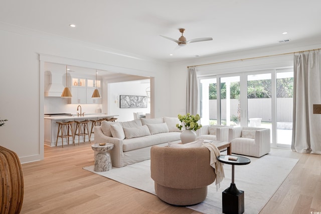 2729 Long Ave, Conway, SC 29526 - living room featuring light wood-style flooring, a ceiling fan, recessed lighting, crown molding, and baseboards