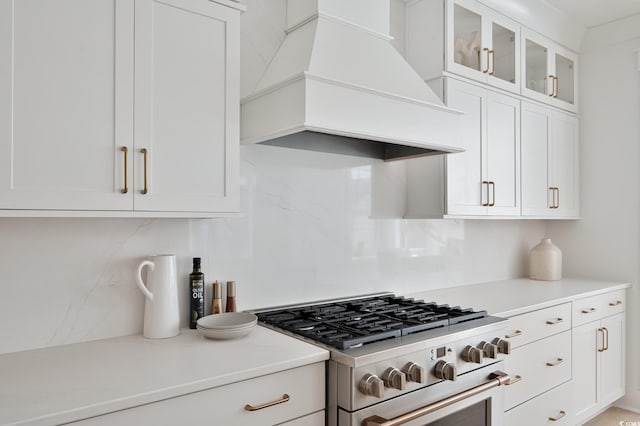 2729 Long Ave, Conway, SC 29526 - kitchen featuring stainless steel gas stove, premium range hood, decorative backsplash, light countertops, and white cabinetry