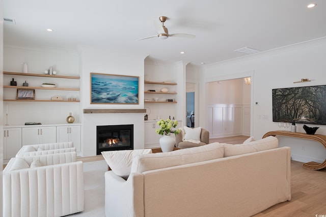 2729 Long Ave, Conway, SC 29526 - living area featuring ceiling fan, ornamental molding, light wood finished floors, a glass covered fireplace, and recessed lighting