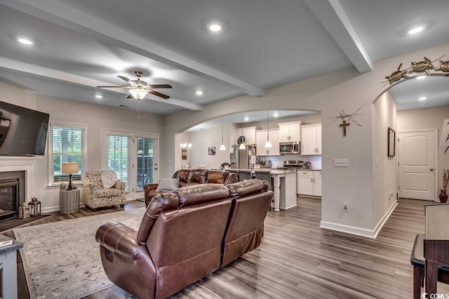 3091 Viceroy Loop, Little River, SC 29566 - living area featuring arched walkways, beamed ceiling, baseboards, dark wood-style floors, and ceiling fan