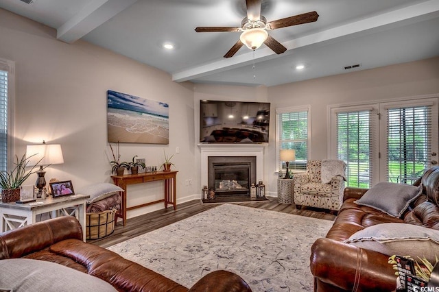 3091 Viceroy Loop, Little River, SC 29566 - living area featuring beamed ceiling, a ceiling fan, wood finished floors, a fireplace with flush hearth, and baseboards