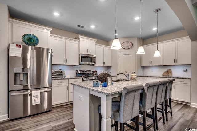 3091 Viceroy Loop, Little River, SC 29566 - kitchen with stainless steel appliances, wood finished floors, tasteful backsplash, and recessed lighting