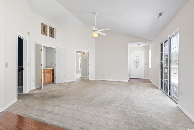 914 Dock Pl, Murrells Inlet, SC 29576 - unfurnished living room with ceiling fan, light colored carpet, baseboards, and high vaulted ceiling