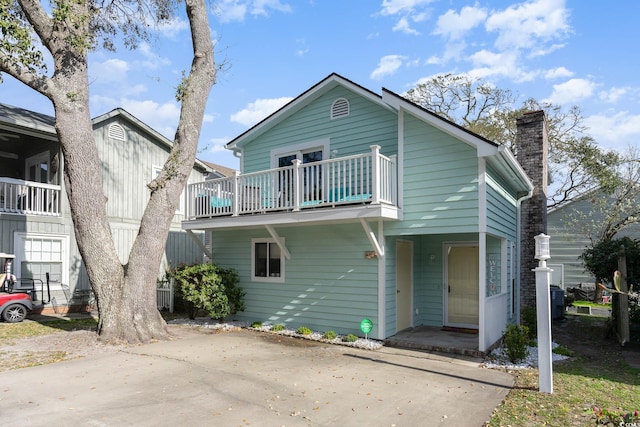 4307 Beverly Ct, North Myrtle Beach, SC 29582 - view of front of home featuring a balcony and a chimney