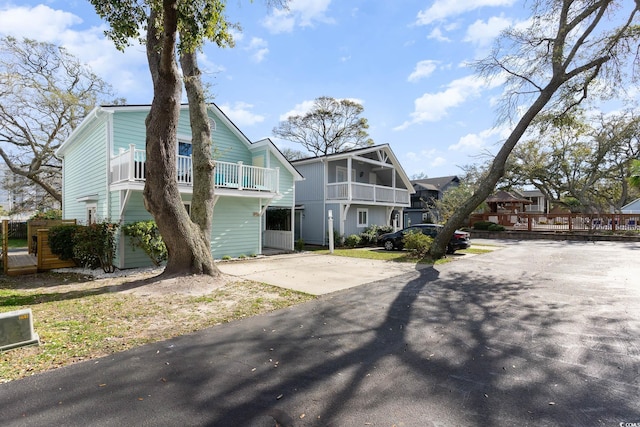 4307 Beverly Ct, North Myrtle Beach, SC 29582 - rear view of house with a residential view, driveway, and a balcony