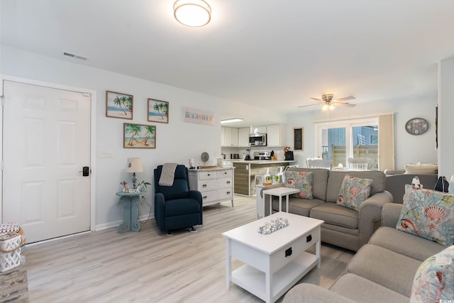 4307 Beverly Ct, North Myrtle Beach, SC 29582 - living area with light wood-style flooring, a ceiling fan, and baseboards