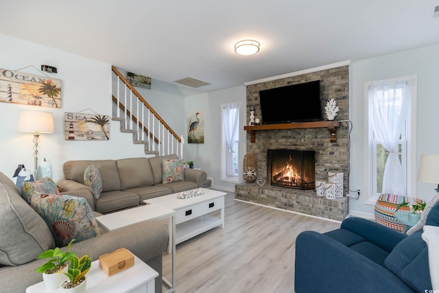 4307 Beverly Ct, North Myrtle Beach, SC 29582 - living area featuring wood finished floors, a fireplace, and stairway