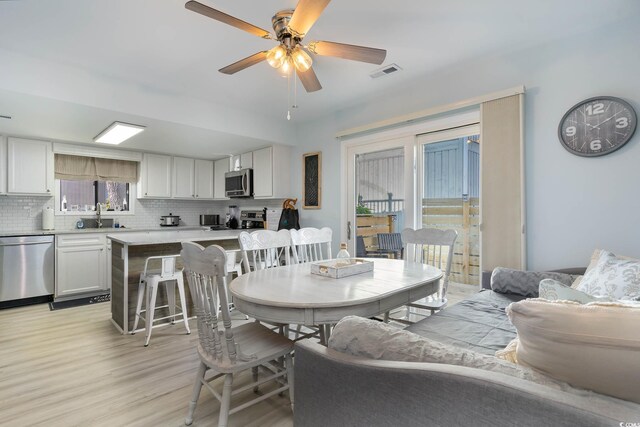 4307 Beverly Ct, North Myrtle Beach, SC 29582 - dining room featuring light wood-style floors and a ceiling fan