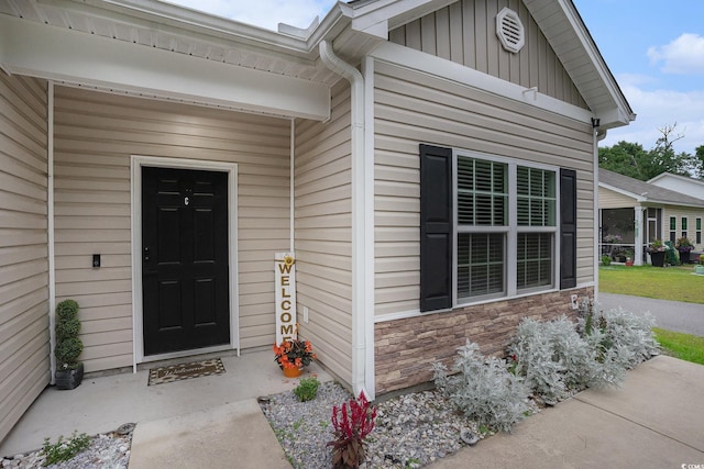 2472 Bayboro St Unit C, Loris, SC 29569 - doorway to property featuring stone siding and board and batten siding