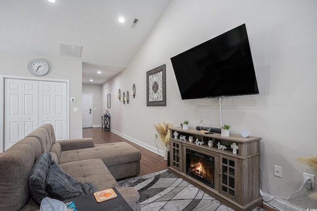 2472 Bayboro St Unit C, Loris, SC 29569 - living room with wood finished floors, vaulted ceiling, baseboards, recessed lighting, and a glass covered fireplace