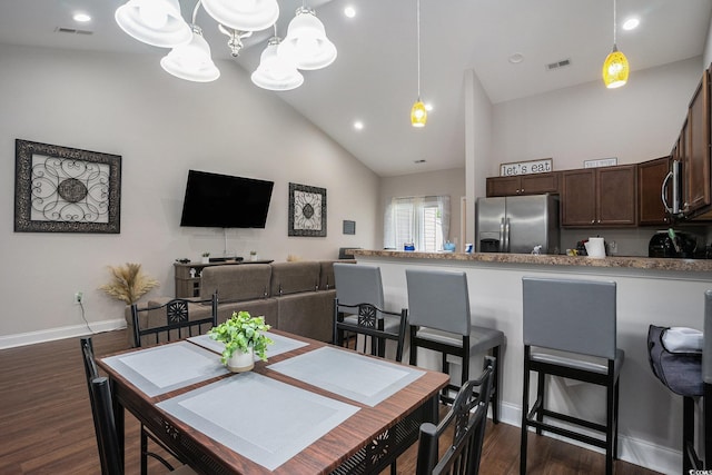 2472 Bayboro St Unit C, Loris, SC 29569 - dining area featuring dark wood-style floors, high vaulted ceiling, a chandelier, and baseboards