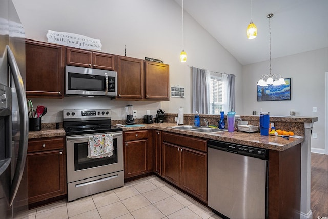 2472 Bayboro St Unit C, Loris, SC 29569 - kitchen with stainless steel appliances, a sink, a peninsula, high vaulted ceiling, and a chandelier