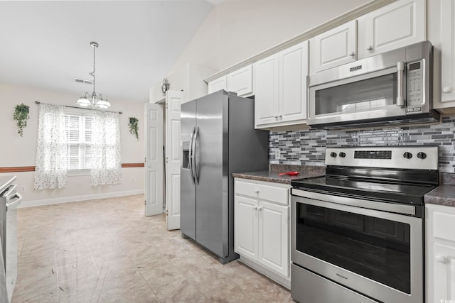 176 Whispering Oaks Dr, Longs, SC 29568 - kitchen with appliances with stainless steel finishes, dark countertops, backsplash, a chandelier, and white cabinets