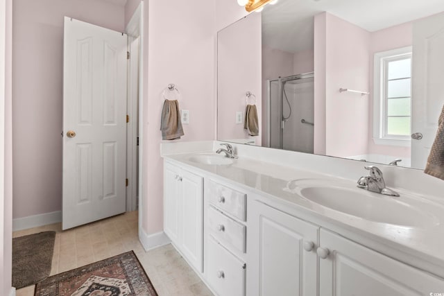 176 Whispering Oaks Dr, Longs, SC 29568 - bathroom with double vanity, a shower stall, and baseboards