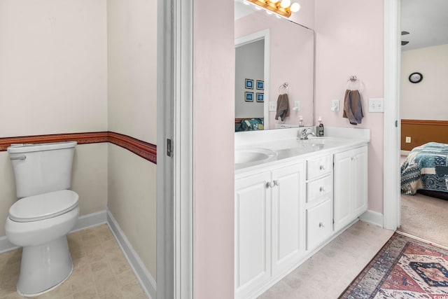 176 Whispering Oaks Dr, Longs, SC 29568 - bathroom featuring double vanity, connected bathroom, toilet, and baseboards