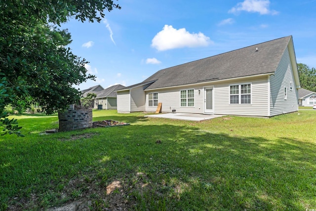 176 Whispering Oaks Dr, Longs, SC 29568 - rear view of house featuring a patio area, a lawn, and roof with shingles
