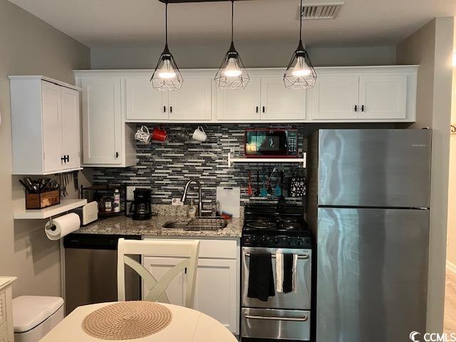 415 Ocean Creek Dr Unit 2117, Myrtle Beach, SC 29572 - kitchen featuring stainless steel appliances, white cabinets, and a sink