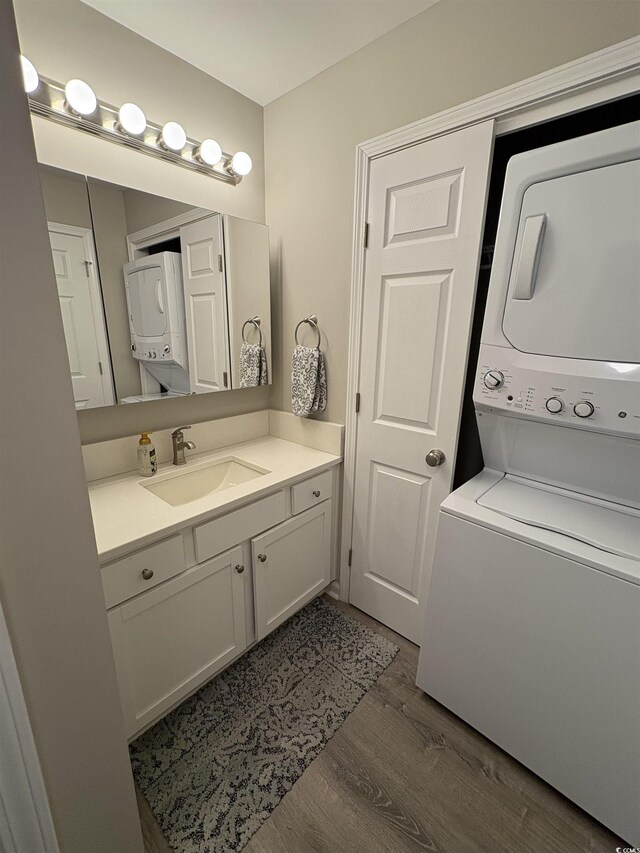 415 Ocean Creek Dr Unit 2117, Myrtle Beach, SC 29572 - bathroom with estacked washer and dryer, vanity, and wood finished floors
