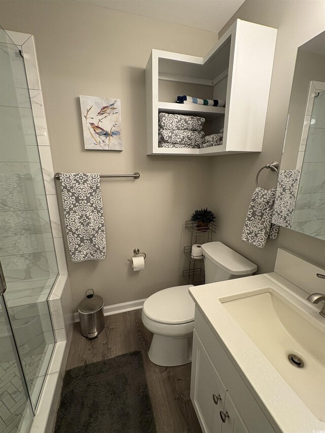 415 Ocean Creek Dr Unit 2117, Myrtle Beach, SC 29572 - bathroom with a shower stall, toilet, wood finished floors, vanity, and baseboards