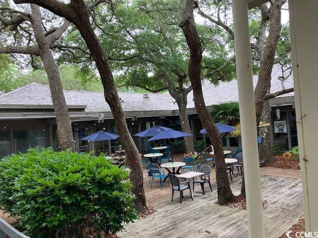 415 Ocean Creek Dr Unit 2117, Myrtle Beach, SC 29572 - wooden deck with outdoor dining area