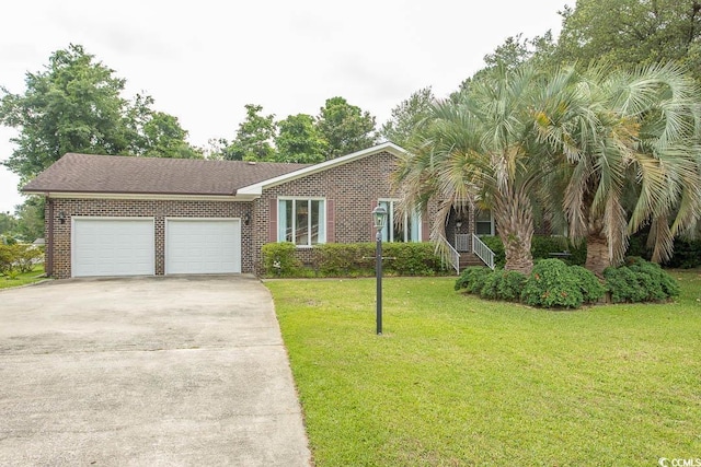 18 Pine Valley Ln, Surfside Beach, SC 29575 - view of front of home with an attached garage, driveway, a front lawn, and brick siding