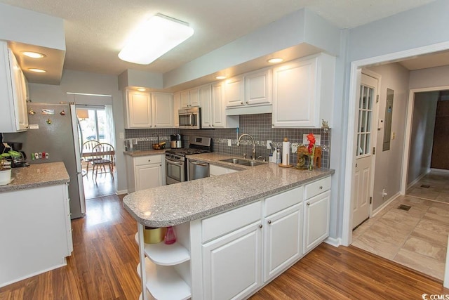 18 Pine Valley Ln, Surfside Beach, SC 29575 - kitchen with a sink, appliances with stainless steel finishes, white cabinetry, backsplash, and open shelves