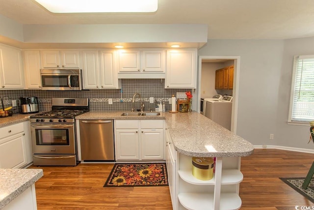 18 Pine Valley Ln, Surfside Beach, SC 29575 - kitchen with appliances with stainless steel finishes, a sink, washer and dryer, open shelves, and white cabinetry