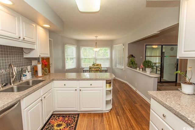 18 Pine Valley Ln, Surfside Beach, SC 29575 - kitchen featuring a sink, stainless steel dishwasher, a peninsula, dark wood finished floors, and backsplash
