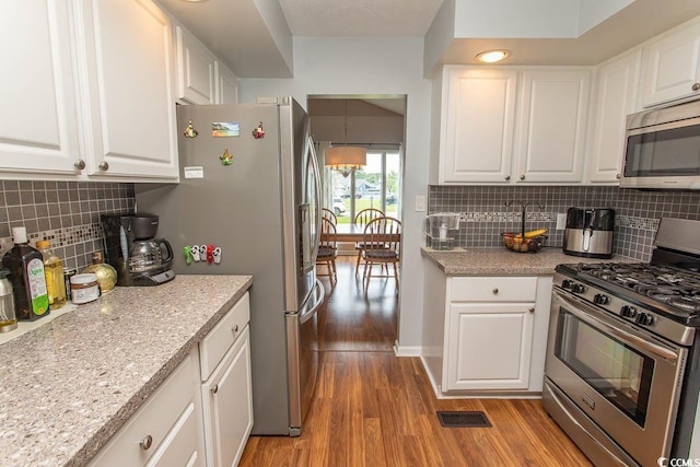 18 Pine Valley Ln, Surfside Beach, SC 29575 - kitchen featuring appliances with stainless steel finishes, light wood-type flooring, white cabinets, and backsplash