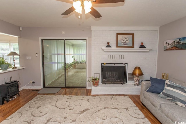 18 Pine Valley Ln, Surfside Beach, SC 29575 - living room with a wood stove, ceiling fan, wood finished floors, and baseboards