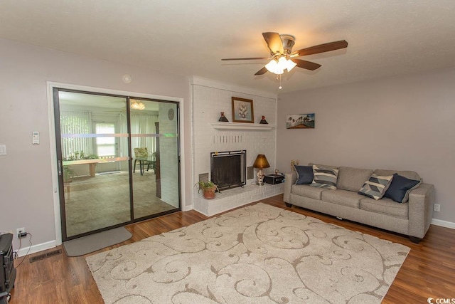 18 Pine Valley Ln, Surfside Beach, SC 29575 - living area featuring a ceiling fan, wood finished floors, baseboards, and a brick fireplace