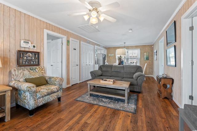 161 Easy St, Garden City Beach, SC 29576 - living room featuring ornamental molding, wood finished floors, ceiling fan, baseboards, and wood walls
