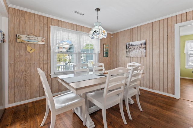 161 Easy St, Garden City Beach, SC 29576 - dining space featuring crown molding, baseboards, wooden walls, dark wood-style flooring, and a chandelier