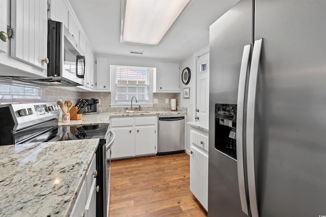 161 Easy St, Garden City Beach, SC 29576 - kitchen with stainless steel appliances, a sink, backsplash, and wood finished floors