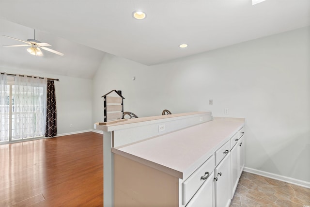 6500 Colonial Dr Unit 2, Myrtle Beach, SC 29572 - kitchen featuring a peninsula, a ceiling fan, lofted ceiling, white cabinetry, and light countertops