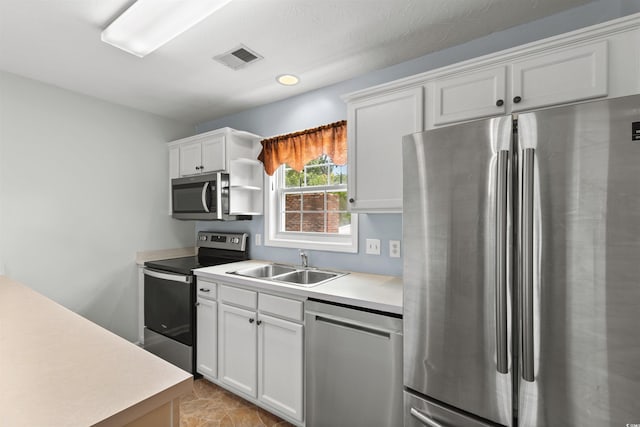 6500 Colonial Dr Unit 2, Myrtle Beach, SC 29572 - kitchen with appliances with stainless steel finishes, light countertops, white cabinetry, and open shelves