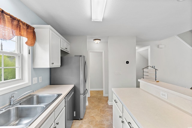 6500 Colonial Dr Unit 2, Myrtle Beach, SC 29572 - kitchen with white cabinets, stainless steel dishwasher, and light countertops